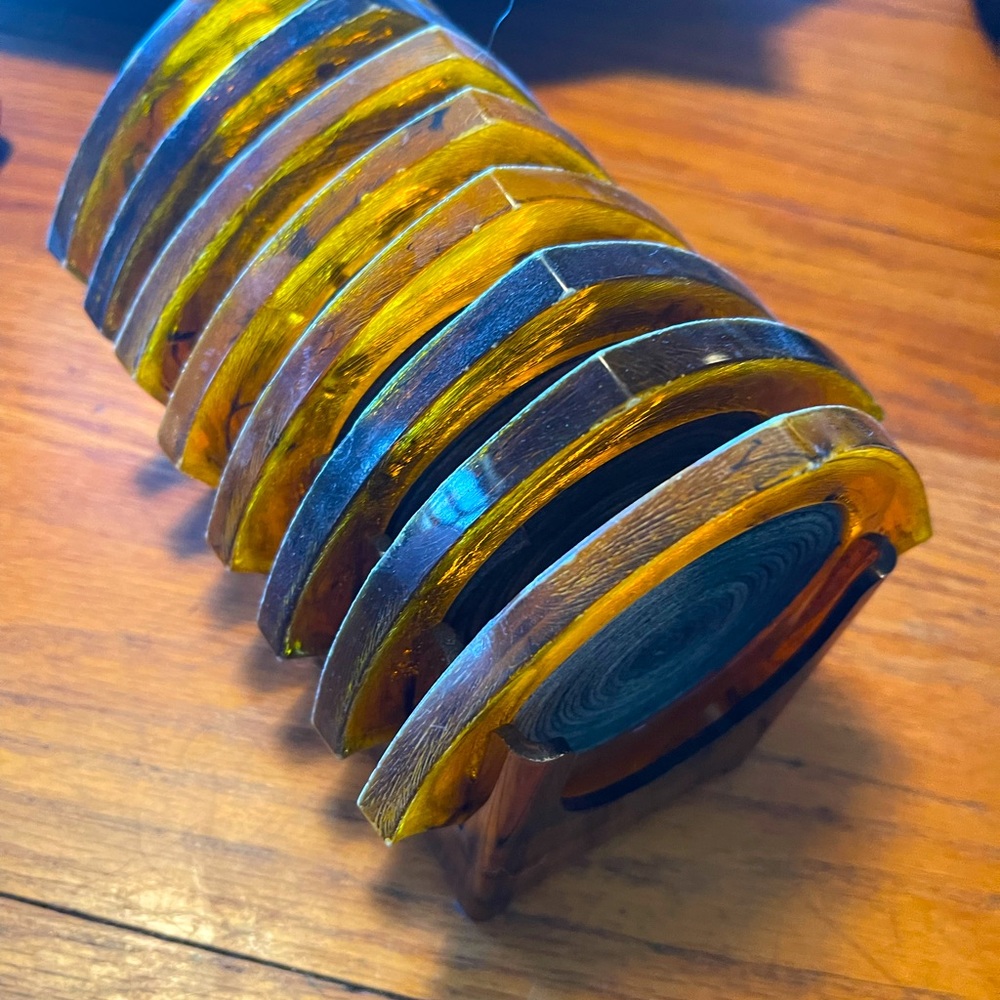 Bakelite coaster set. Amber in color  nice condition for its age. Mid century